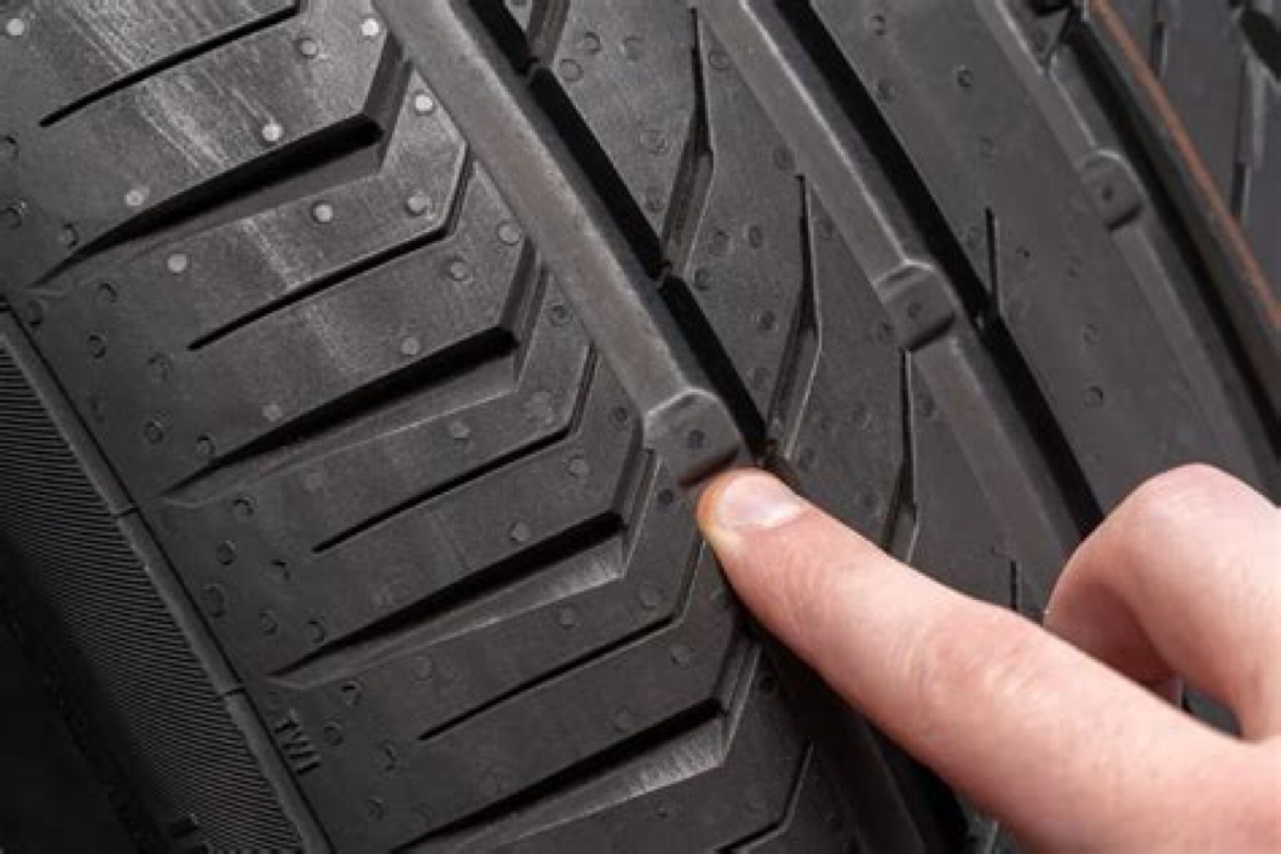 Tread wear indicator — the raised bar between the grooves. When it's flush with the tread, the tire is done.